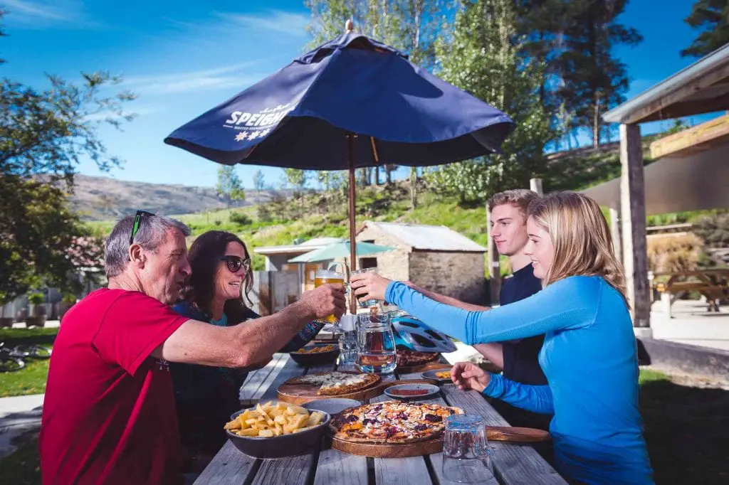 Riders enjoying beer and pizza at the Gibbston Tavern
