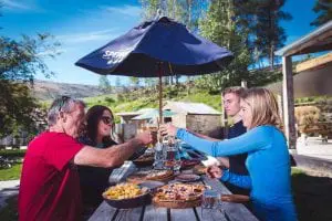 Riders enjoying beer and pizza at the Gibbston Tavern