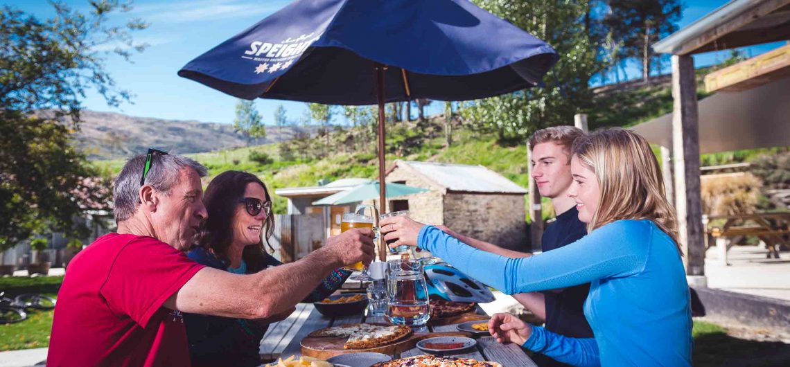 Riders enjoying beer and pizza at the Gibbston Tavern