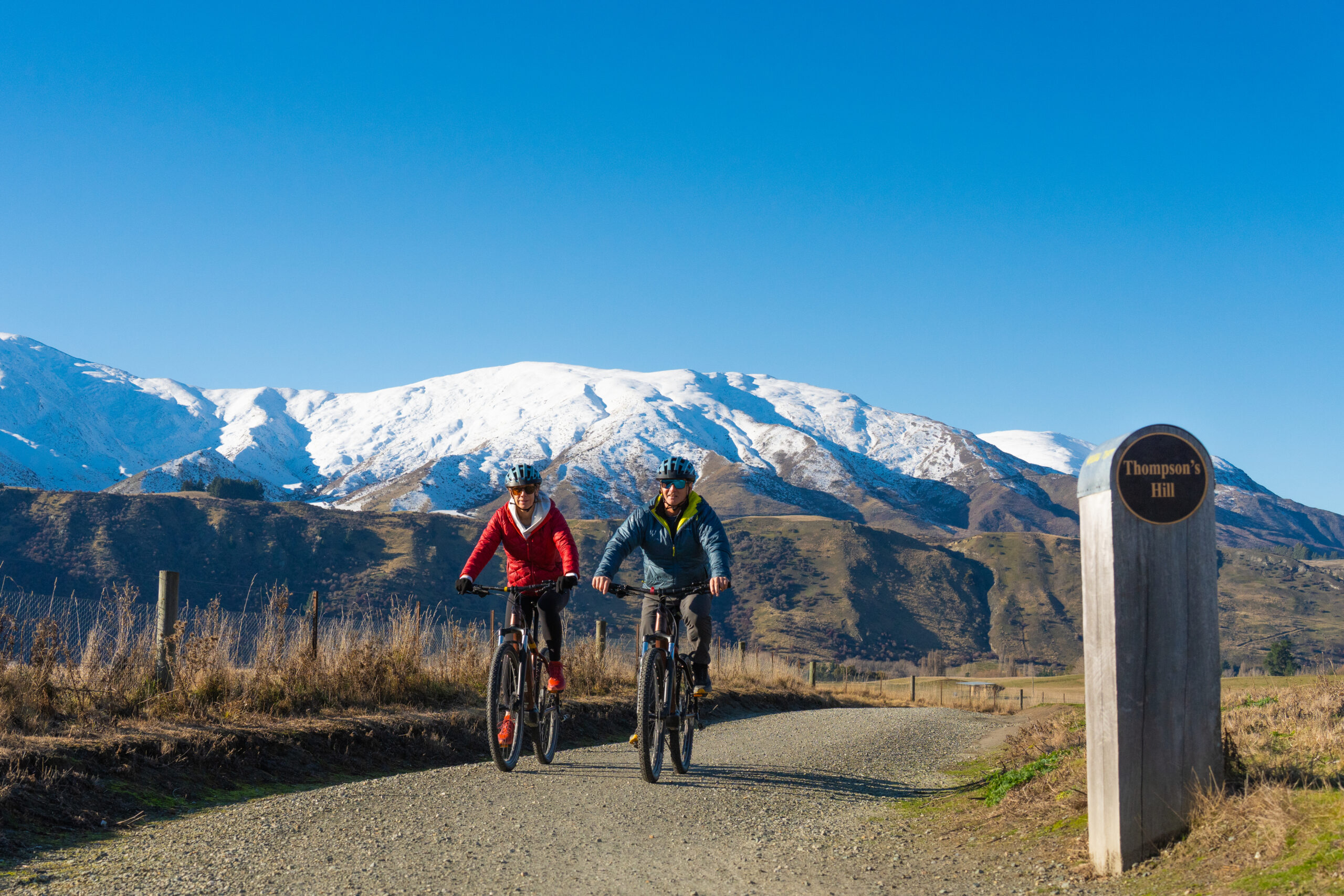 Two Electric Bike riders at the top of Thompsons Hill on the Queenstown Trail