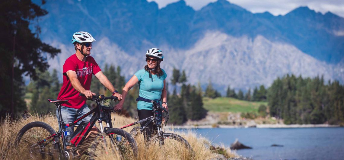 Riders enjoying the view on the Queenstown Trail, near the Queenstown Gardens