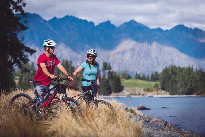 Riders enjoying the view on the Queenstown Trail, near the Queenstown Gardens