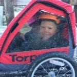 Kids loving the warm trailer on a winter bike tour.