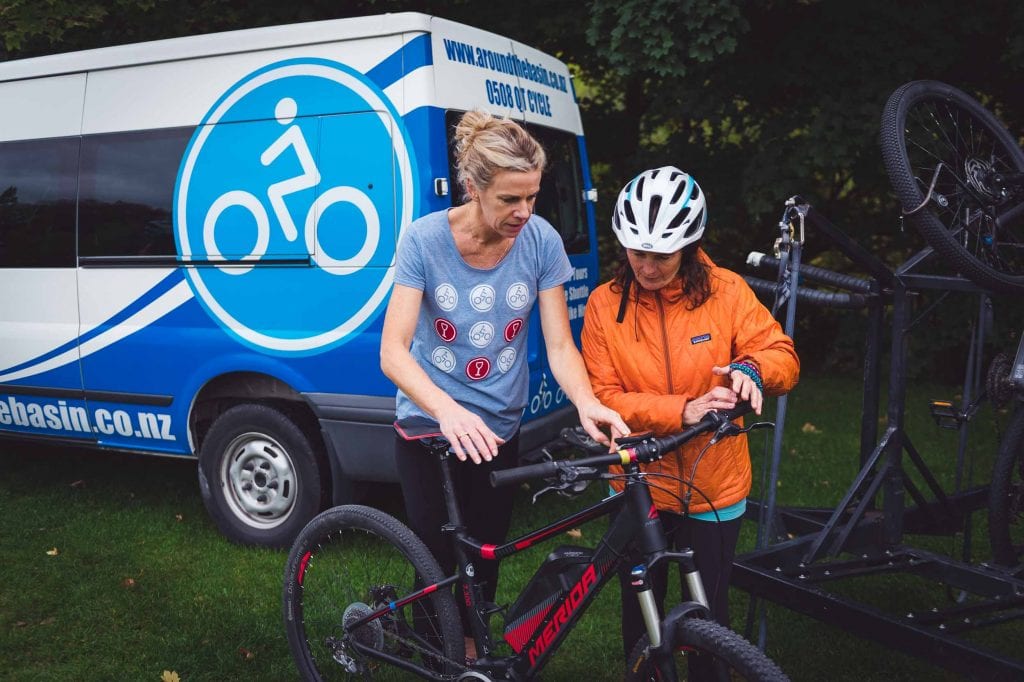 Guide Lisa setting up a client with an electric bike