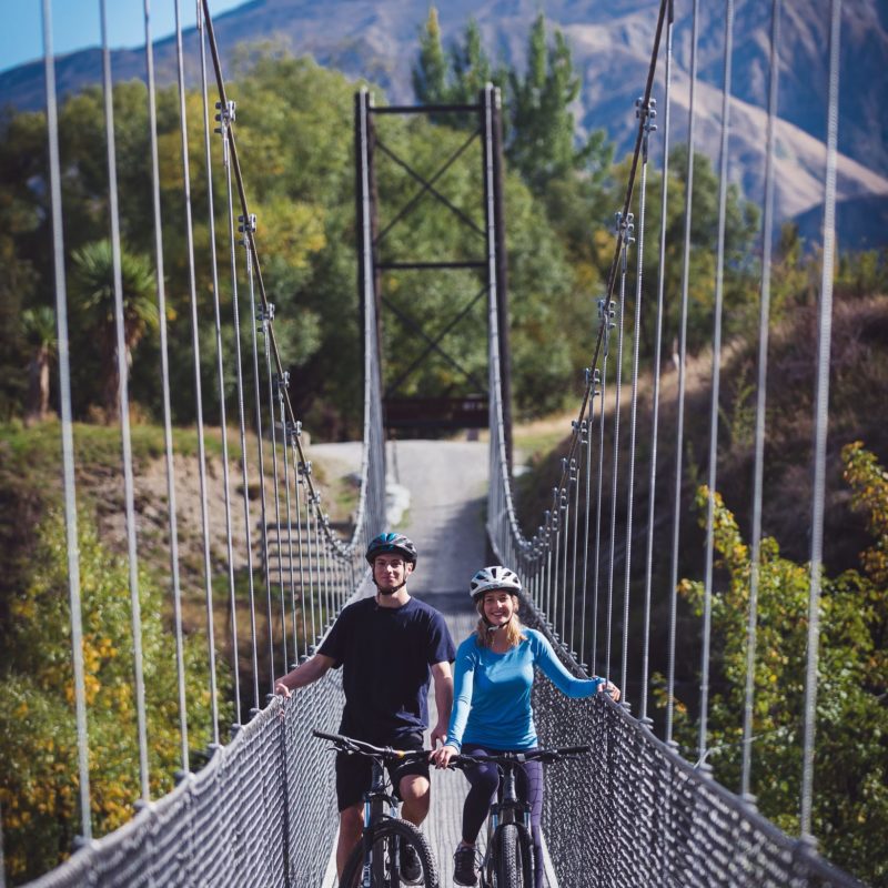 Bike riders on the Southern Discoveries Bridge, near Arrowtown